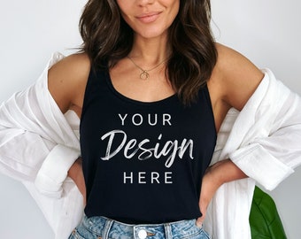 May include: A black tank top with the text "YOUR Design HERE" in white. The model is wearing the tank top with a white shirt and denim shorts.