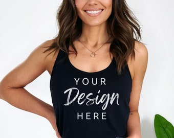 May include: A woman wearing a black tank top with the text "YOUR Design HERE" in white. She is wearing blue denim shorts and has her hands in her pockets.