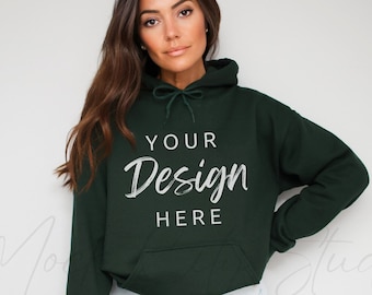 May include: A dark green hooded sweatshirt with the text "YOUR Design HERE" printed on the front.