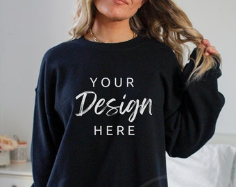 May include: A black oversized sweatshirt with the text "YOUR Design HERE" printed on the front.