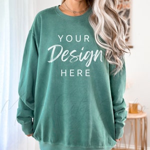 Pode incluir: Uma camisa de moletom verde de tamanho grande com o texto "YOUR Design HERE" em branco.
