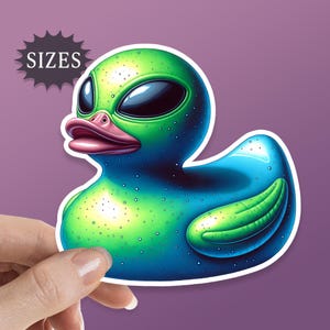 May include: A green and blue rubber duck with alien-like eyes and a pink beak. The duck has a speckled texture and a white outline.