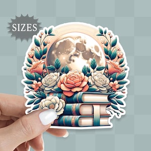 May include: A sticker featuring a stack of books with a moon and floral design. The moon is white with a gray and blue marbled pattern. The flowers are pink, white, and green. The books are blue, green, and brown.