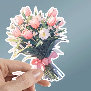 May include: A bouquet of pink and white flowers tied with a pink ribbon. The bouquet is made up of tulips and other white flowers.