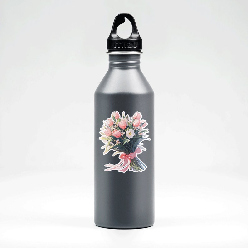 May include: A gray reusable water bottle with a black lid and handle. A sticker of a pink and white flower bouquet is on the bottle.