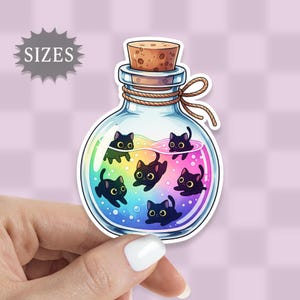 May include: A sticker featuring a glass bottle with a cork stopper, filled with rainbow liquid and cartoon black cats. The bottle is tied with a brown rope. The word "SIZES" is in a gray starburst shape.