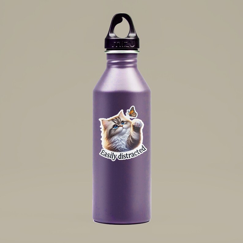May include: A purple stainless steel water bottle with a black lid and a sticker of a cat looking at a butterfly with the text "Easily distracted".