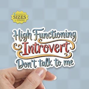 May include: A white sticker with the text "High Functioning Introvert Don't talk to me" in a colorful, whimsical font. The sticker also includes the text "WATERPROOF SIZES + FINISH" in a yellow badge.
