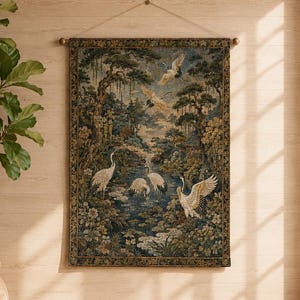 May include: A rectangular wall tapestry featuring a detailed woven scene of white cranes in a lush forest landscape with a pond, trees, and floral elements. The tapestry is suspended from a wooden rod with a thin string for hanging on a wall.