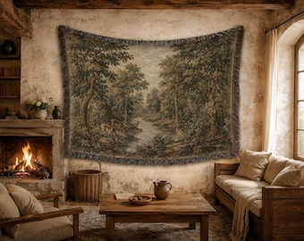 May include: A rectangular woven wall tapestry featuring a detailed landscape scene with a flowing river, dense green trees, and wildlife including deer and a bird. The tapestry has a fringed border and is displayed hanging on a textured wall.