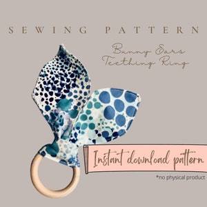 May include: A bunny ears teething ring sewing pattern. The ears are made of fabric with blue and white patterns, attached to a natural wood ring. The text "SEWING PATTERN" and "Bunny Ears Teething Ring" are displayed. The words "Instant download pattern" are also visible.
