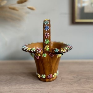 Peut inclure: Un petit pot en céramique brun avec une poignée décorée de fleurs colorées. Le pot a une finition en bois et est parfait pour les petites plantes ou les succulentes.