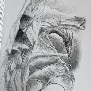 May include: A pencil sketch of a dragon emerging from behind a rock formation. The dragon has detailed wings and a long neck, with a detailed texture. The artwork is in black and white, with shading to create depth and dimension.