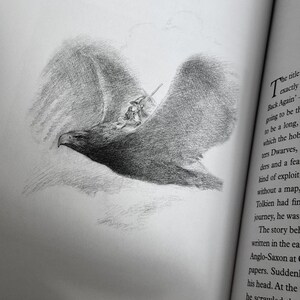 May include: A pencil sketch illustration of a large eagle in flight, carrying a small figure. The eagle's wings are spread wide, and the drawing is detailed with shading. The image is from a book, with text visible on the right side.