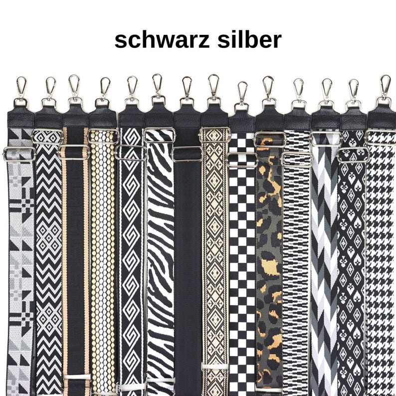 May include: A set of 14 black and white patterned straps with silver hardware. The straps are made of woven fabric and have a variety of geometric, animal print, and striped designs.