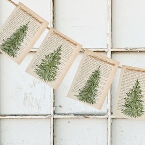 May include: A rustic Christmas banner with a string of 10 flags featuring a green tree illustration on each flag. The flags are made of brown paper with a vintage book page texture.