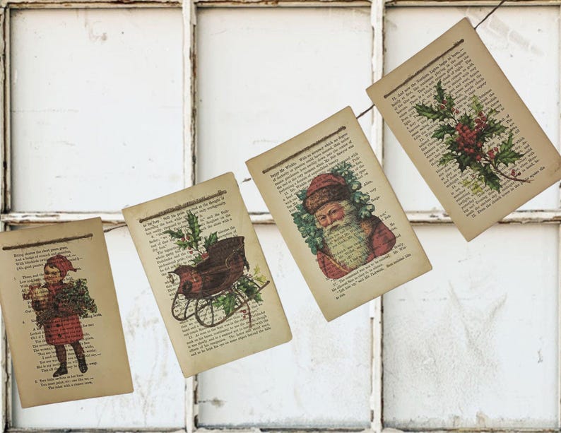 Puede incluir: Una guirnalda de p&aacute;ginas de libros antiguos con ilustraciones navide&ntilde;as. Las im&aacute;genes incluyen un ni&ntilde;o, Pap&aacute; Noel, un trineo y acebo. Las p&aacute;ginas est&aacute;n unidas con hilo, creando una decoraci&oacute;n r&uacute;stica para las fiestas.