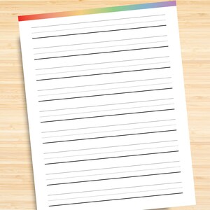 May include: A blank white sheet of paper with black lines, perfect for writing or drawing. The paper has a rainbow colored border at the top.