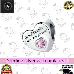 May include: A silver heart charm with the words "Grand Daughter Love you forever" and a pink heart-shaped gem. The image also includes the text "Sterling silver with pink heart". A jewellery item, suitable as a gift.