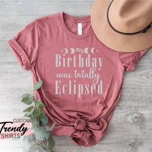 a t - shirt that says, you're a birthday was totally eclipsed