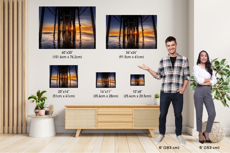 May include: A comparison of different sizes of a photograph of a pier at sunset. The photograph shows a wooden pier extending into the water with the sun setting in the background. The pier is reflected in the water. The image shows the different sizes of the photograph available for purchase.