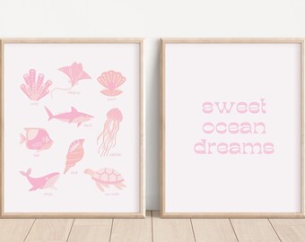 May include: Two framed prints with a pink and white color scheme. The left print features illustrations of various sea creatures with their names written below each image. The right print has the text "sweet ocean dreams" in a pink font.