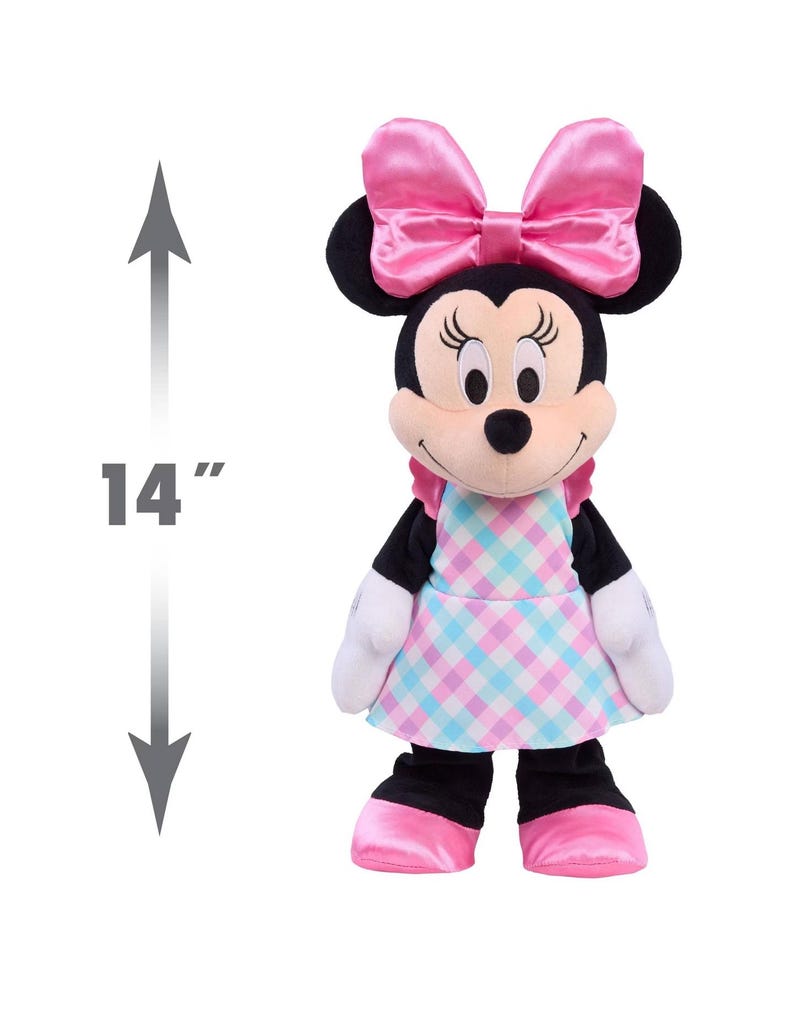May include: A 14-inch Minnie Mouse plush toy. The plush has a pink bow, a pink and blue checkered dress, and pink shoes. The toy has black ears, arms, and legs, and white gloves.
