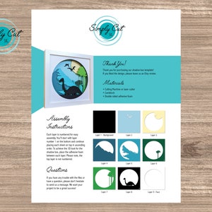 May include: A digital download of a shadow box template featuring a dinosaur silhouette with a green, blue, and yellow colour scheme. The template includes assembly instructions and a list of materials needed, including a cutting machine, cardstock, and double-sided adhesive foam.