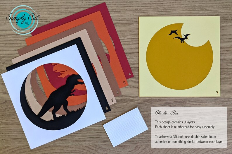 May include: A 9-layer papercraft shadow box kit featuring a silhouette of a dinosaur in a sunset scene. The kit includes 9 numbered sheets of paper, a white base, and instructions for assembly. To achieve a 3D look, use double-sided foam adhesive between each layer.