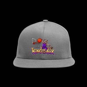 May include: A grey baseball cap featuring a graphic of a raccoon in a purple jersey dunking an orange basketball into a hoop. Below the graphic, the text reads "KING OF THE 6IX" in stylised yellow and purple lettering with a small yellow crown icon.