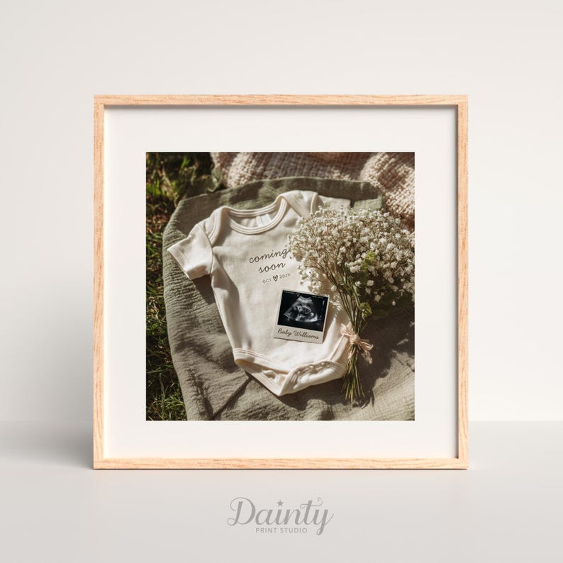 May include: A framed photograph featuring a baby onesie with the words "coming soon" and a sonogram image. A bouquet of white flowers and a soft blanket complete the scene. The frame is light wood.