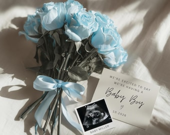 May include: A bouquet of light blue roses tied with a matching ribbon. A card reads "We're excited to say we're having a Baby Boy" with a sonogram image and the date 10.2026. The card also includes the text "Baby Miller" and "Dainty Print Studio."