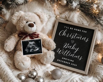 May include: A beige teddy bear with a burgundy bow tie holds an ultrasound image. A black letter board with the text "I'll be home for Christmas Baby Williams arriving December 202X" sits next to the bear. Silver ornaments and Christmas decor surround the bear.
