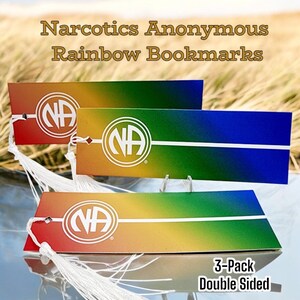 May include: Three double-sided bookmarks with a rainbow gradient design and the NA logo. The bookmarks have white tassels and the text "3-Pack Double Sided".