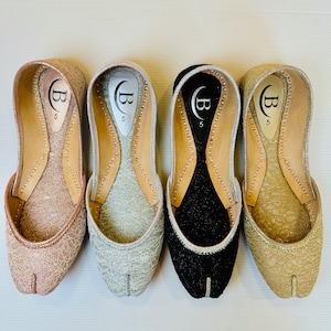 May include: Four pairs of women's shoes with different colored leather uppers. The shoes are all the same style, with a pointed toe and a low heel. The shoes are all size 5.