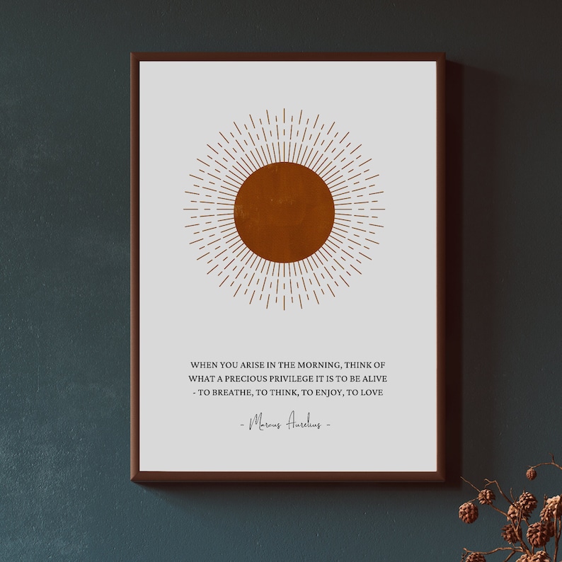 May include: A white poster with a brown sun graphic and a quote by Marcus Aurelius that reads: "When you arise in the morning, think of what a precious privilege it is to be alive - to breathe, to think, to enjoy, to love."