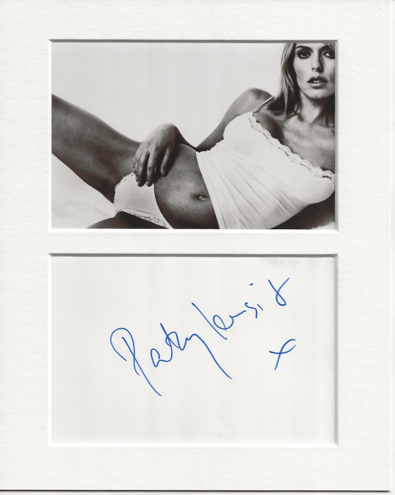 May include: Black and white photo of a woman in a white tank top and underwear. The photo is signed "Patty  Lessit" in blue ink.
