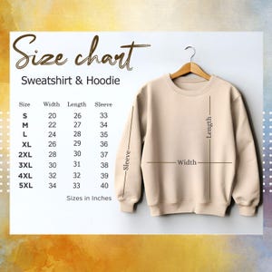 May include: A beige sweatshirt hangs on a wooden hanger, with a size chart displayed to the left. The chart lists sizes S to 5XL, with measurements in inches for width, length, and sleeve length. The text "Size chart Sweatshirt & Hoodie" is at the top.