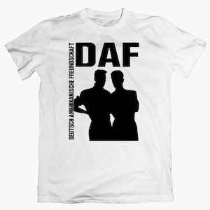 May include: White t-shirt with a black silhouette of two people and the text "DAF" and "DEUTSCH AMERIKANISCHE FREUNDSCHAFT" on the front.