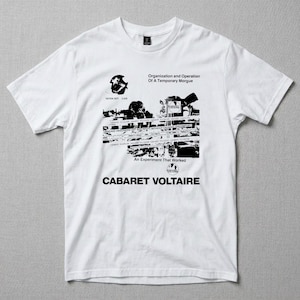 May include: White t-shirt with a black graphic design. The design includes the text "Organization and Operation Of A Temporary Morgue" and "CABARET VOLTAIRE". The shirt has short sleeves and a crew neck.