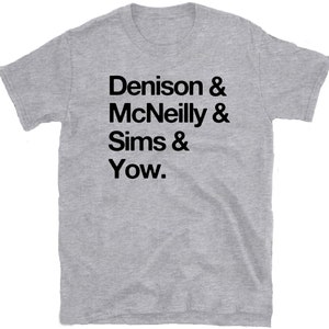 May include: Gray t-shirt with black text that reads "Denison & McNeilly & Sims & Yow."