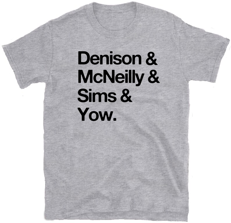 May include: Gray t-shirt with black text that reads "Denison & McNeilly & Sims & Yow."