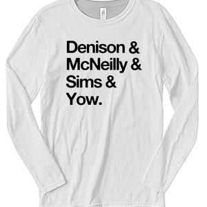 May include: White long-sleeve t-shirt with black text that reads "Denison & McNeilly & Sims & Yow."
