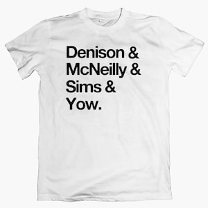 May include: White t-shirt with black text that reads "Denison & McNeilly & Sims & Yow."