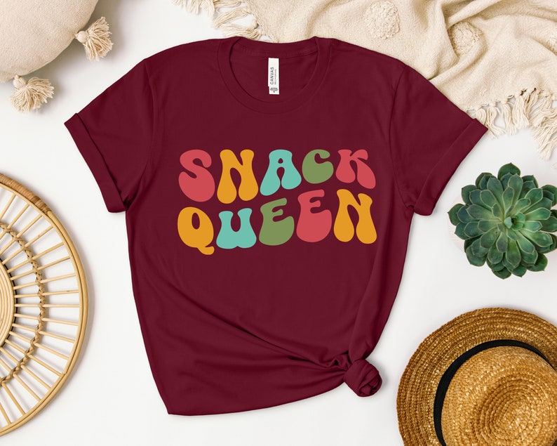 a t - shirt with the words snack queen printed on it