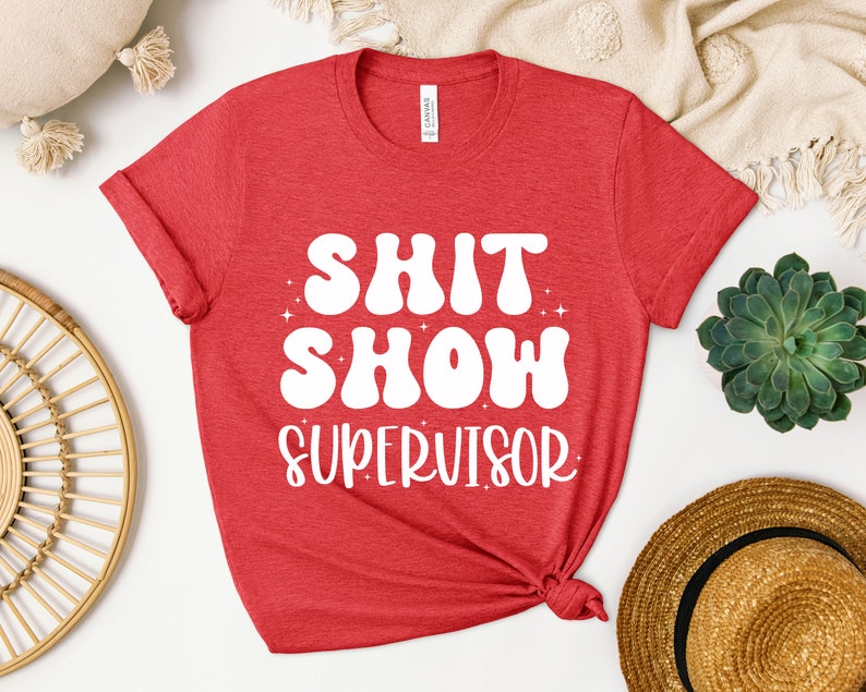 a red shirt that says shit show supervisor