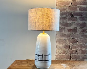 Table lamp made of ceramic vintage 1950s vase in white and black, linen shade in retro style.