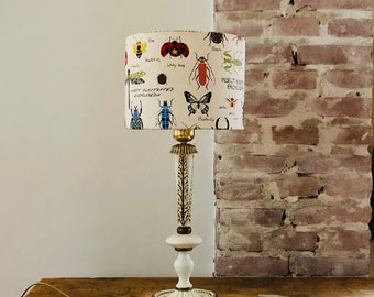 Vintage table lamp from authentic Italian antique lamp base made of metal in gold and cream, special textile shade with insects.