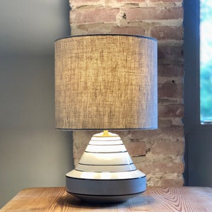 Table lamp in neutral colors, ceramic vase in special shape in white and black. Linen hood. image 2