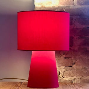 Lámpara de mesa moderna de diseño en color rojo. Una lámpara que marca tendencia. Diseño único.